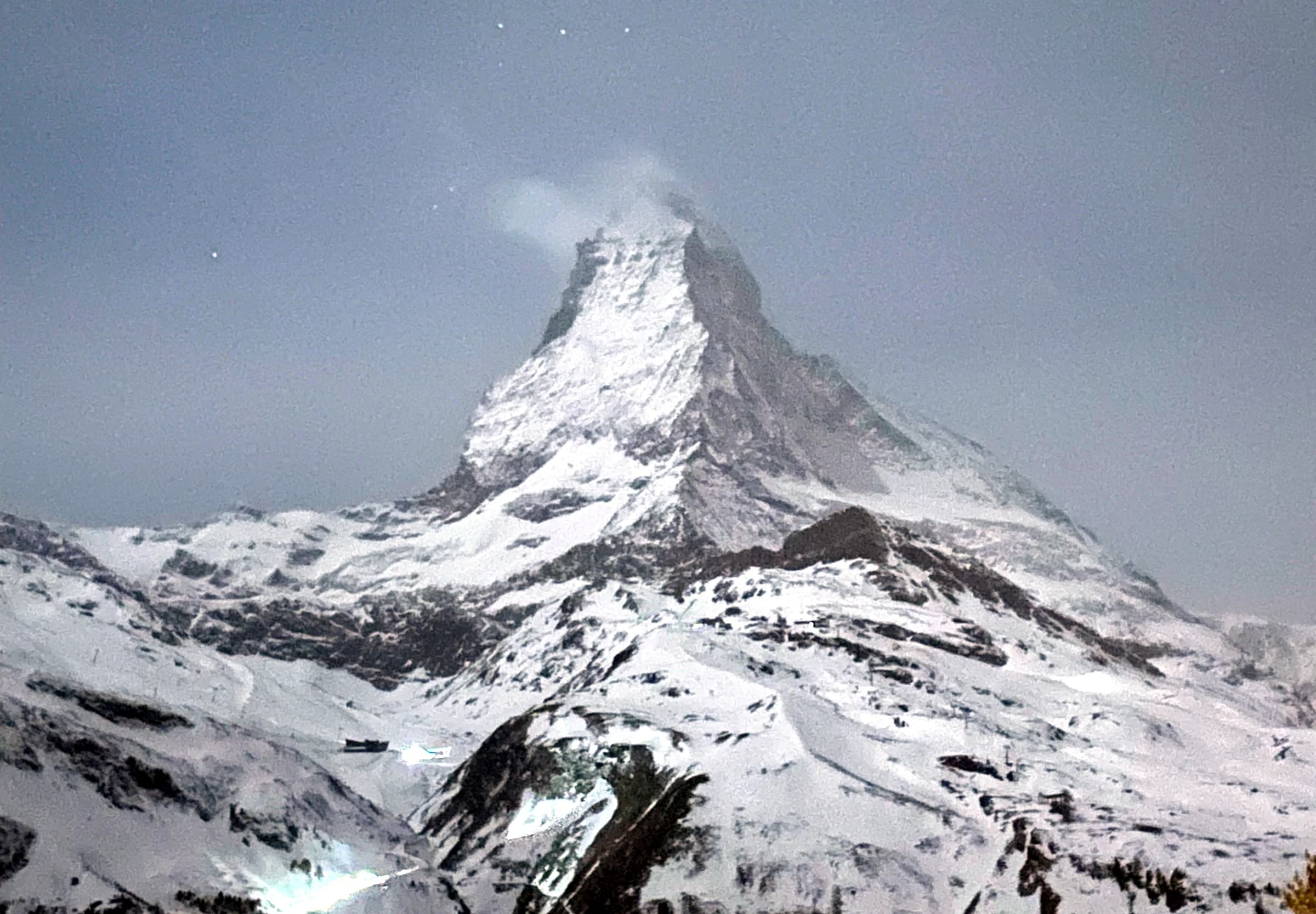 The Matterhorn rising above snowfields beneath a moonlit sky.